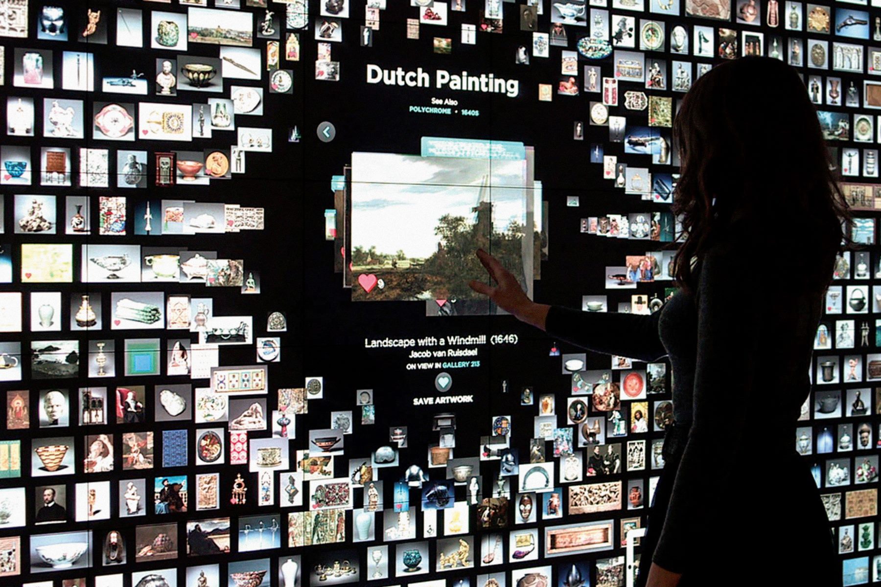 A visitor exploring the Collections Wall, showing live collection data for a Jacob van Ruisdael painting