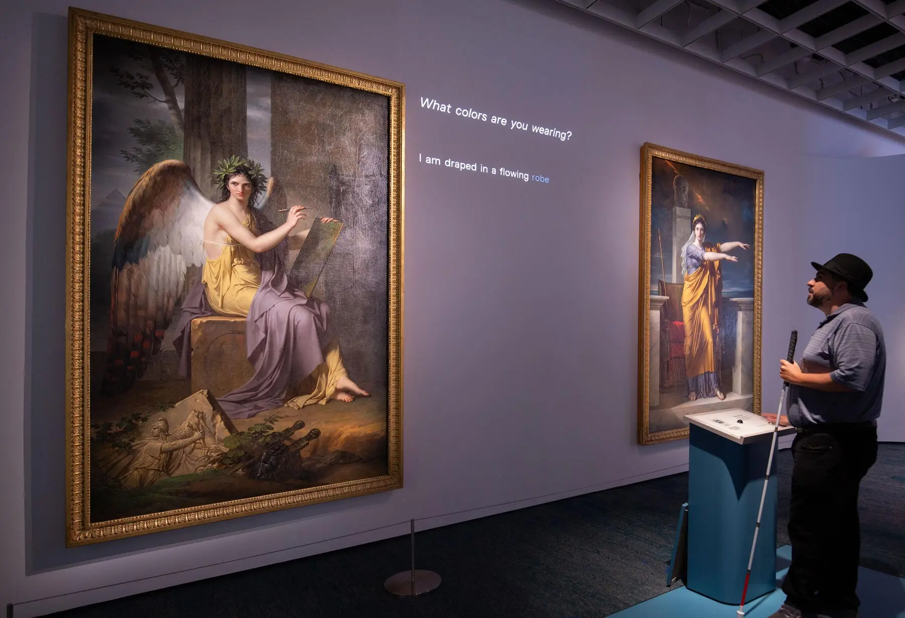 A visitor using a cane at the Look Closer interactive, which answers a visitor's spoken question with an AI-generated description of a painting's details