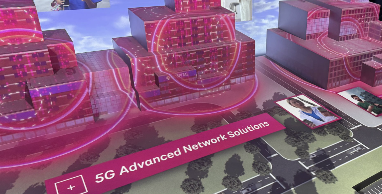 Close-up of the physical model with a projected 5G network-coverage overlay on a hospital building, labeled "5G Advanced Network Solutions"