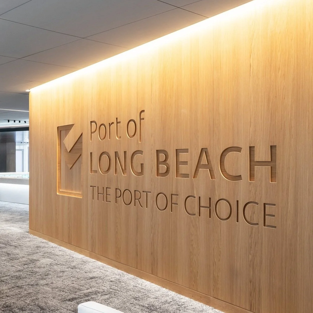 Wood-paneled entry wall reading "Port of Long Beach — The Port of Choice"
