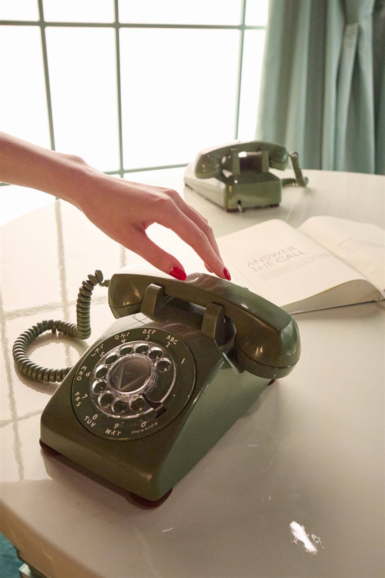 A rotary telephone staged on a desk in the Marilyn's Office room at Genesis House