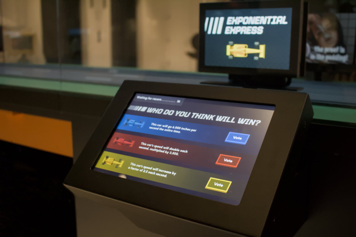 Formula Fun touchscreen asking visitors to predict which car will win