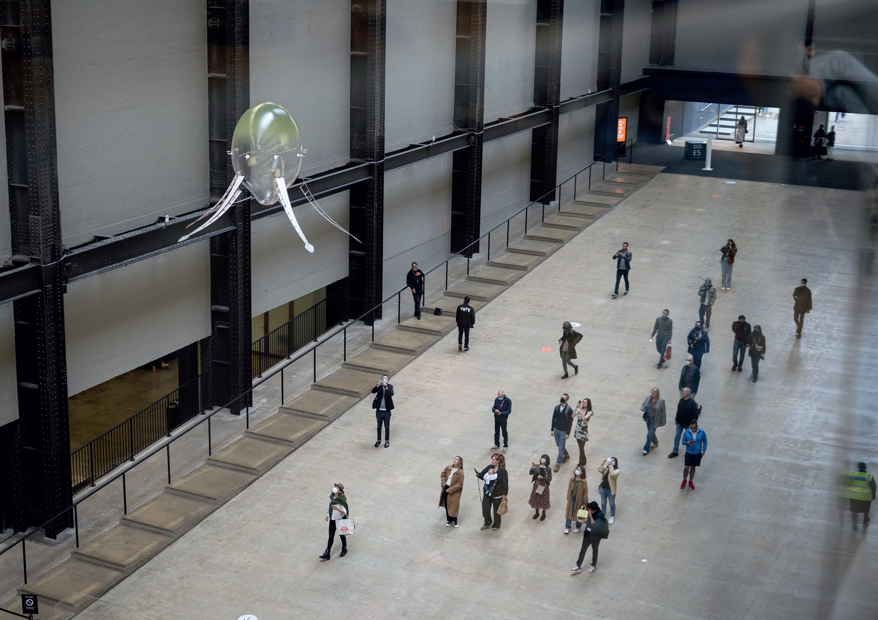 An Aerobe machine suspended over a crowd of visitors in the Tate Modern's Turbine Hall.